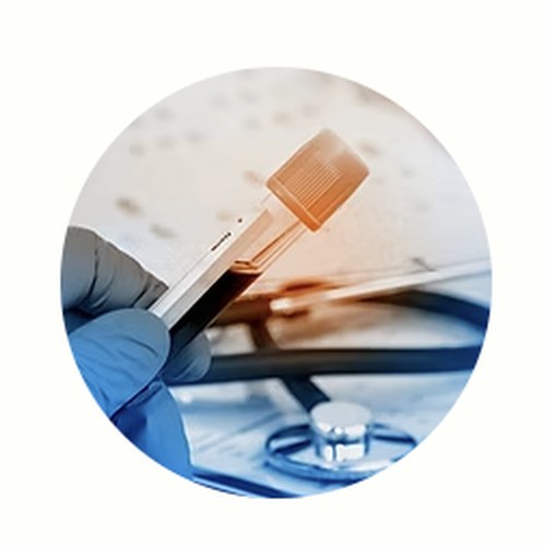 Gloved hand holding blood collection tubes