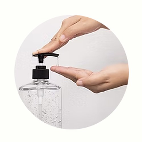 Hand receiving sanitizer from a pump bottle
