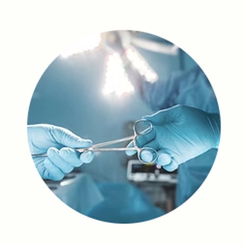 Surgeon's gloved hands using surgical instruments